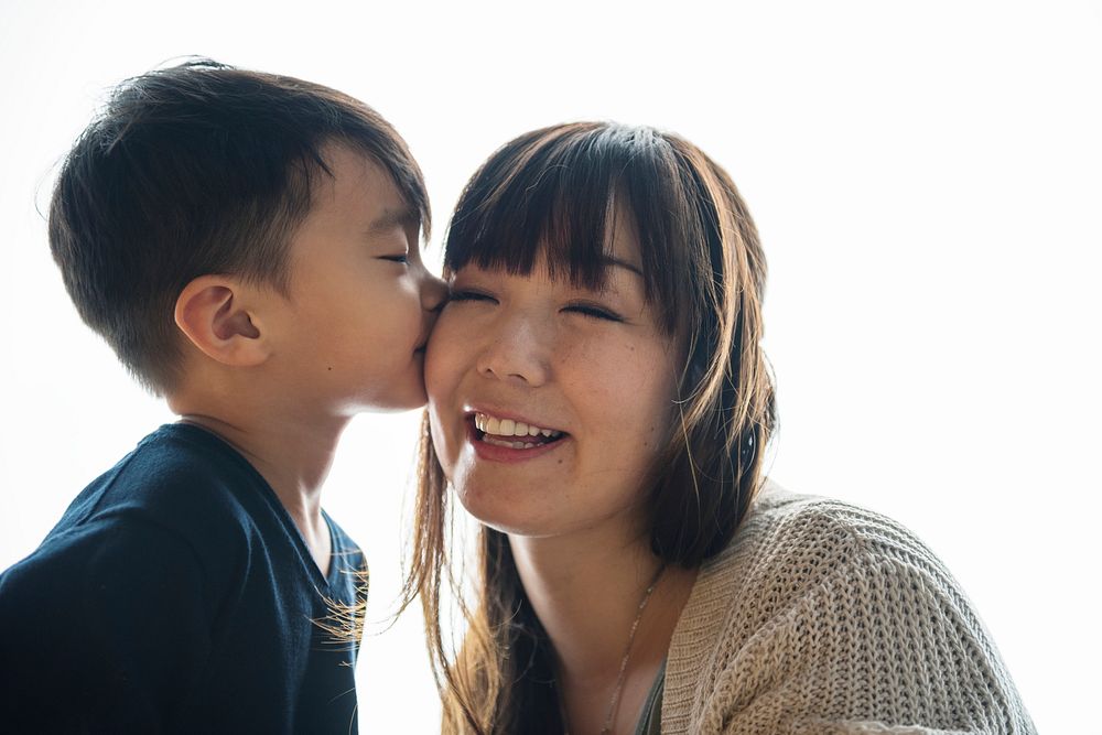 Japanese boy kissing his mother