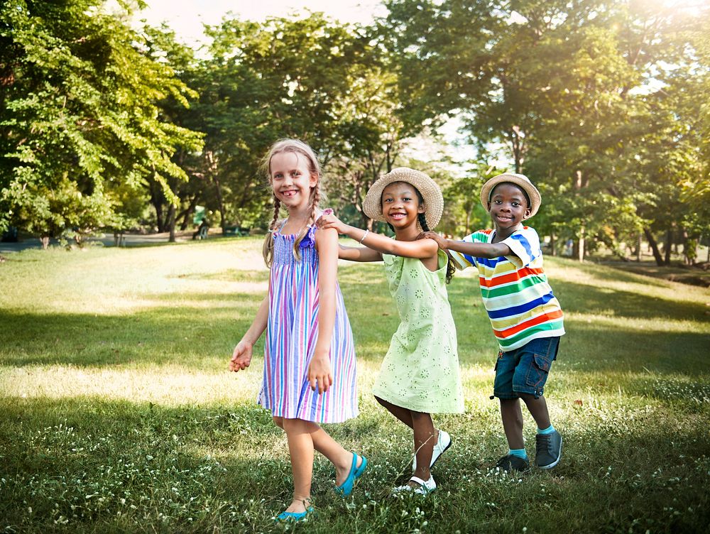 Cute diverse kids playing in the park