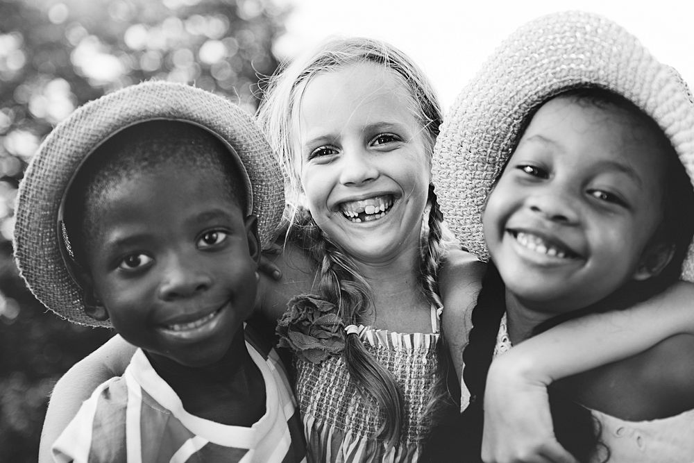 Closeup group of diverse smiling kids grayscale