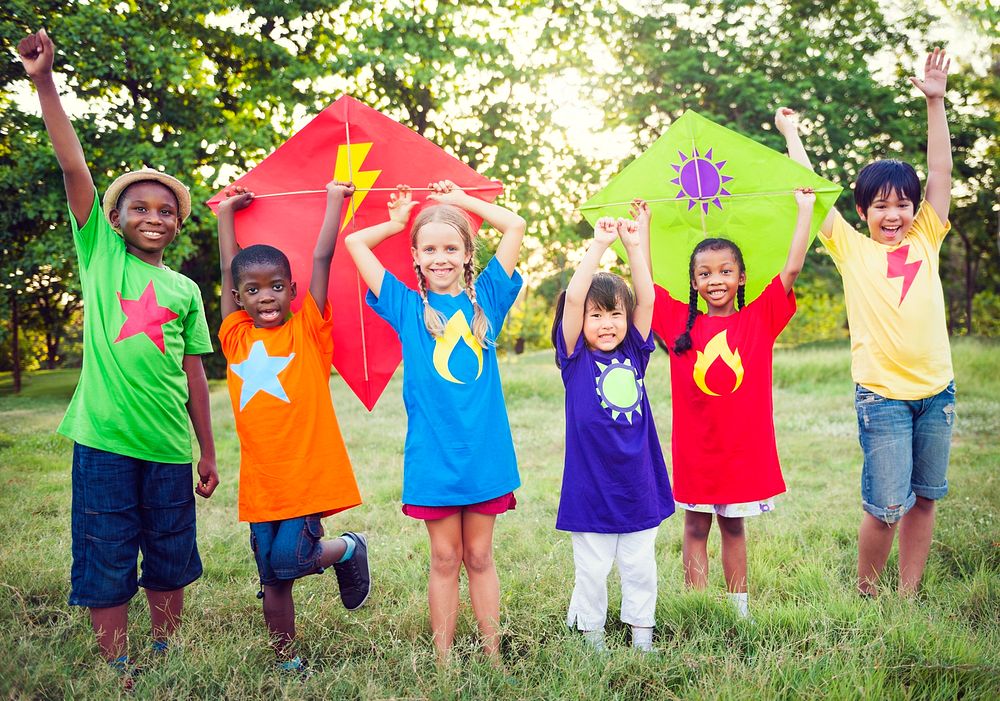 Diverse kids in colorful shirts holding kites