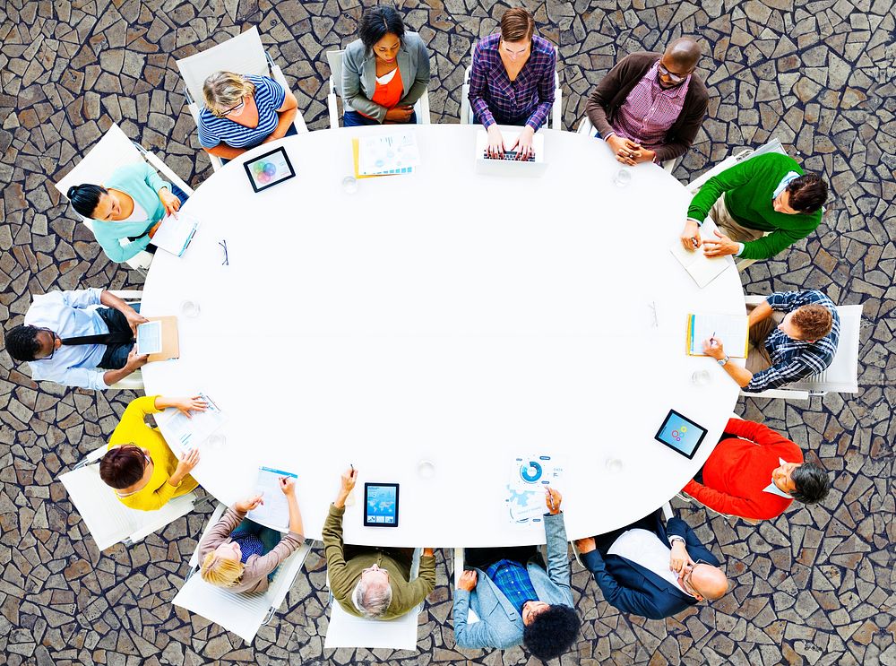 Aerial view of people seated around a meeting table