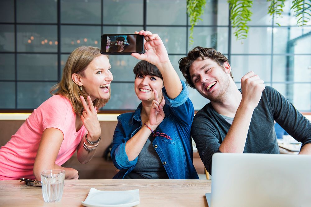 Group of friends is taking selfie photo together