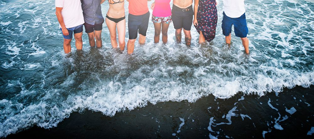 People standing in a row in the water