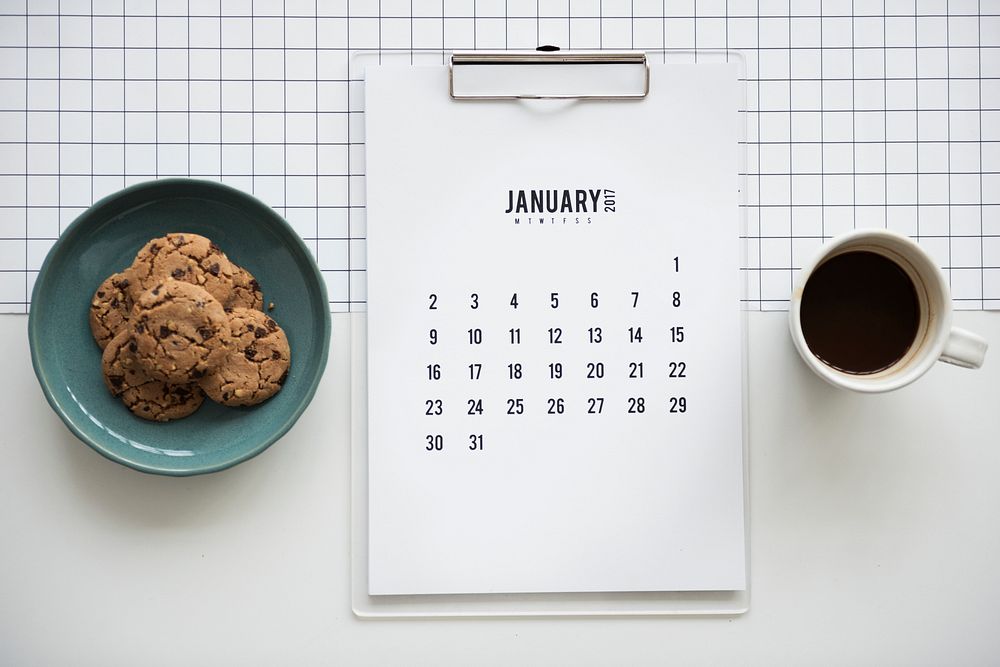 Cookie, calendar and coffee flatlay 