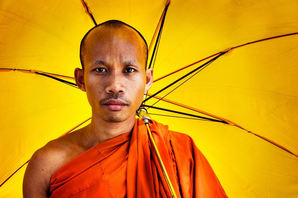 Buddhist monk holding an umbrella