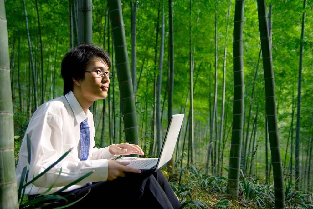 Businessman working in the forest