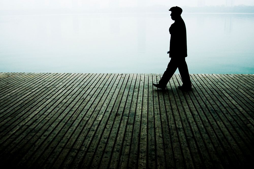 Chinese man walking on the boardwalk