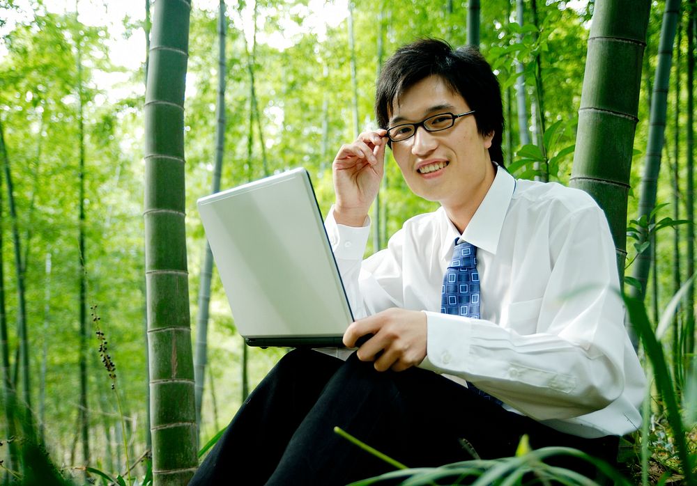 Businessman sitting in a bamboo forest.