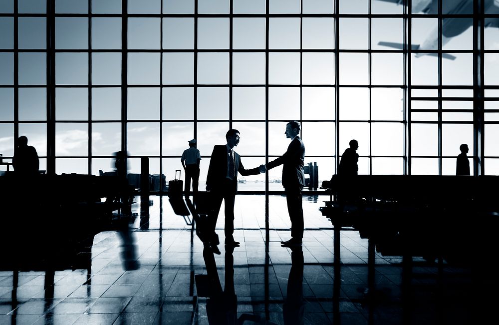 Businessmen Handshake Deal Airport Terminal Concept