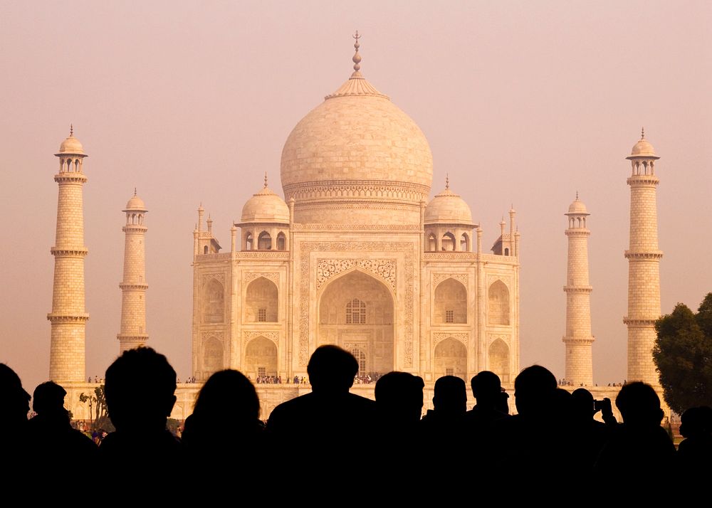 View of the Taj Mahal with tourist silhouettes