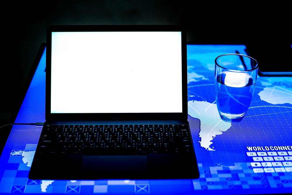 Laptop on a digital desk cyber space
