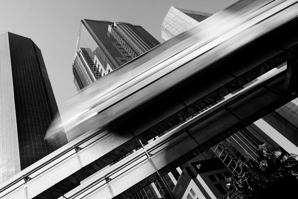 Motion blur of a skytrain speeding through a modern business district.