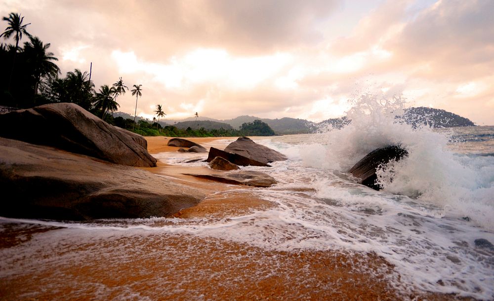 The power of the sea on a tropical beach at sunset