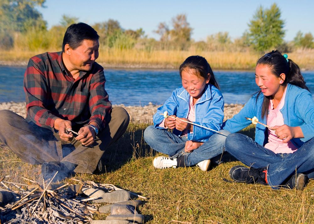 Mongolian family enjoy camping by the river.