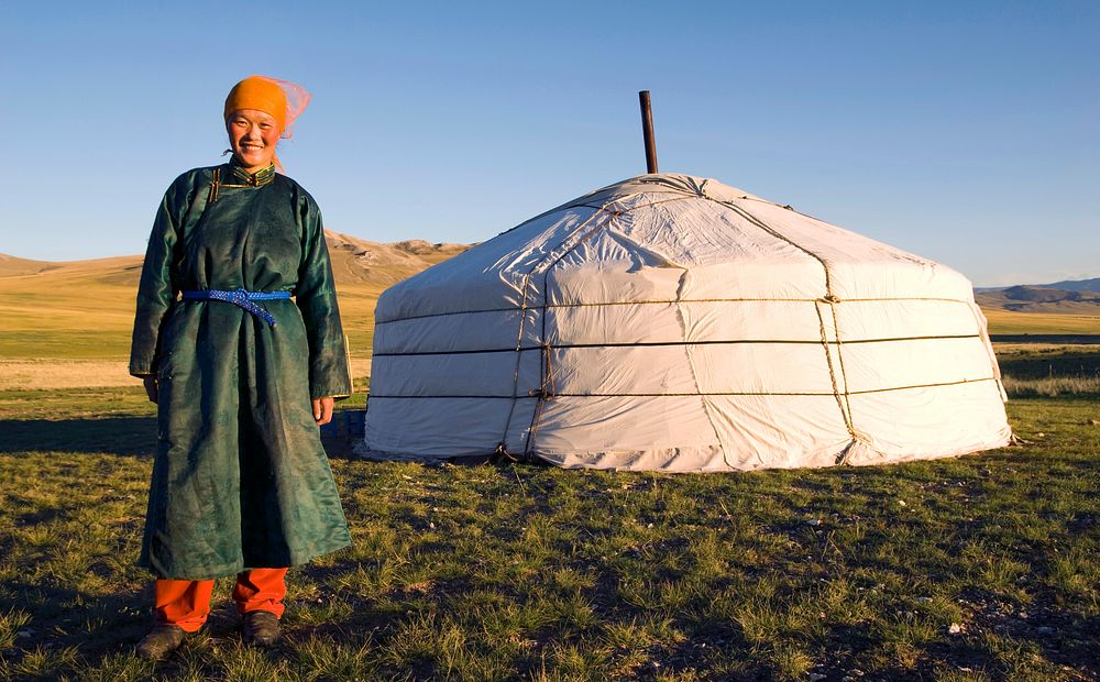 Mongolian woman standing in front of a ger