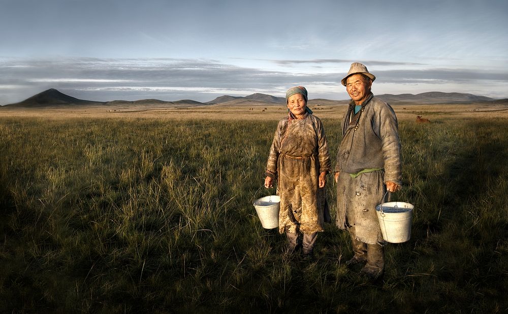 Mongolian farmers holding basin in the field