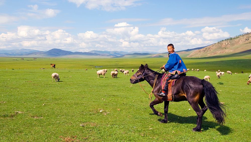 Boy riding a horse in Mongolia