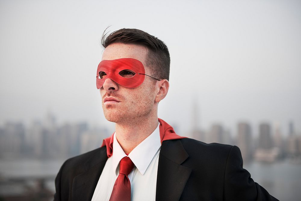 Closeup of businessman wearing red superhero costume