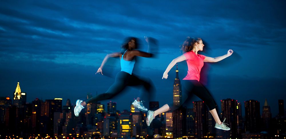 Two young women jogging at night time