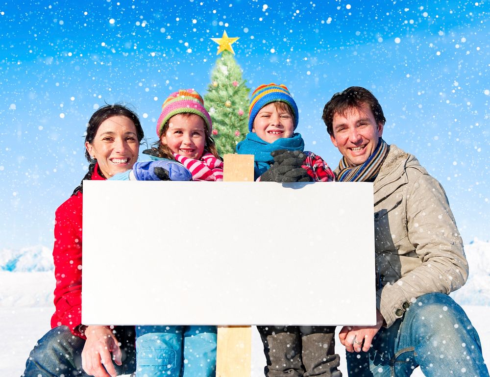 Christmas family with placard on winter.