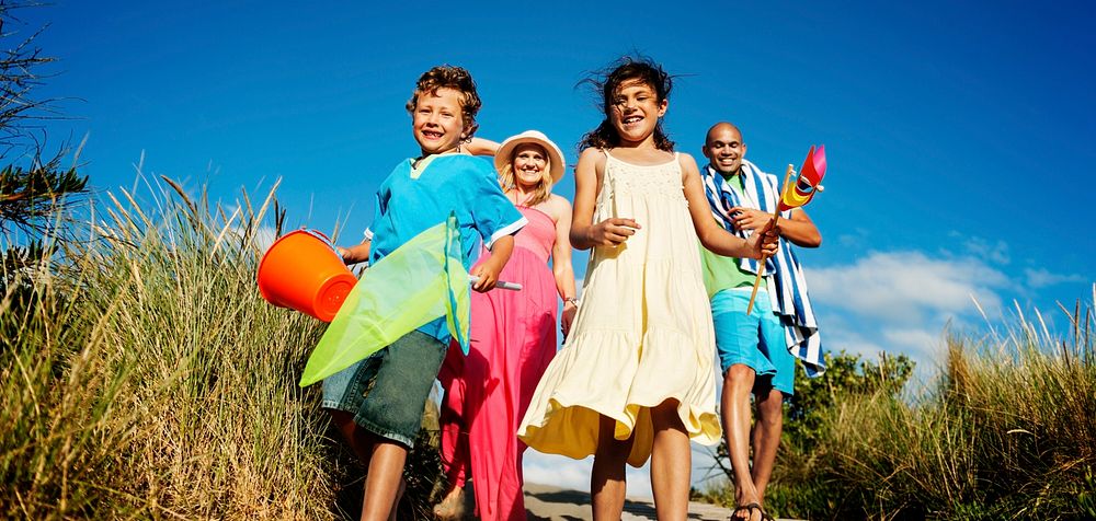 Cheerful Family Bonding by the Beach Holiday Concept