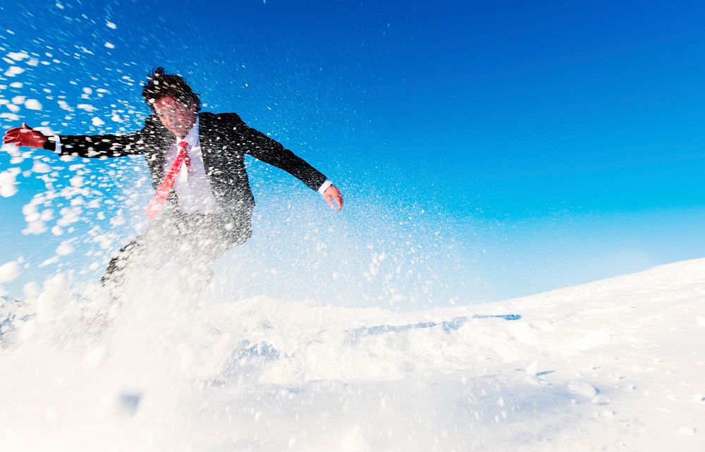 Businessman snow boarding.