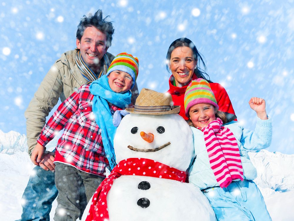 Family posing with a snowman outdoors.