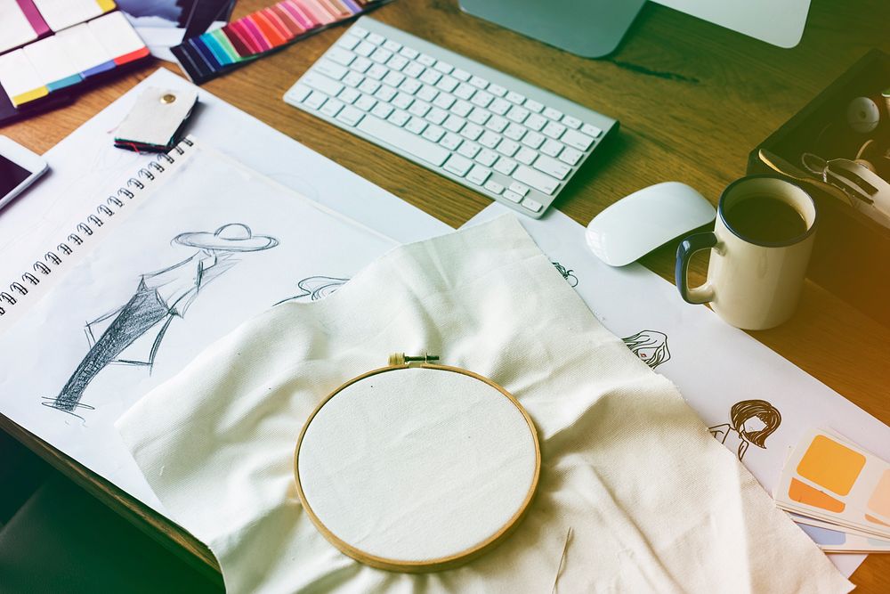Fashion design messy workspace on wooden table