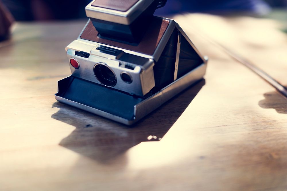 Vintage retro instant camera on table