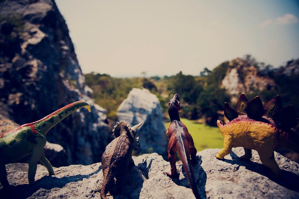 Dinosaur figure toy on the top of mountain