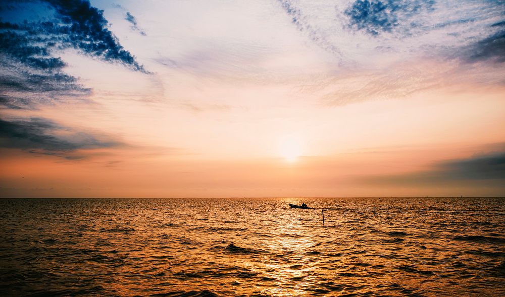 Boat in the ocean at sunset
