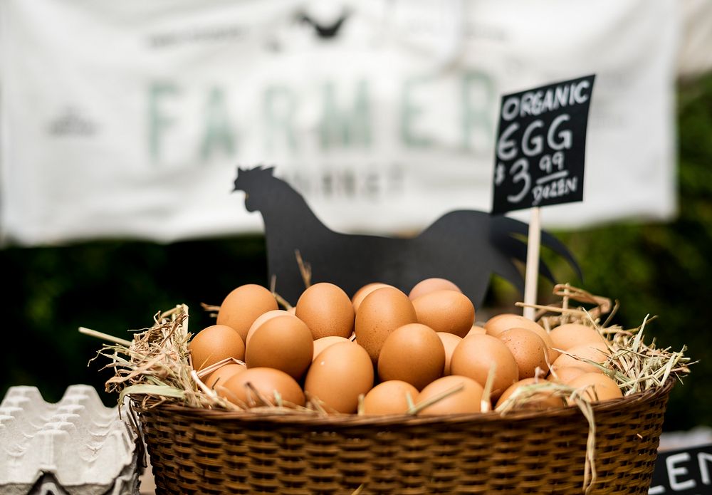 Fresh Chicken Rooster Eggs on Hay at Local Farmer Market