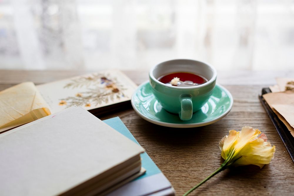 Cup of tea on a table with books