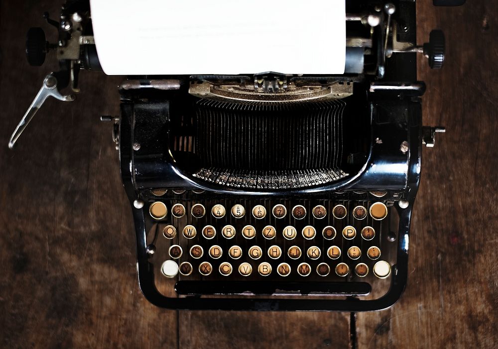 Vintage style typewriter on a wood desktop 