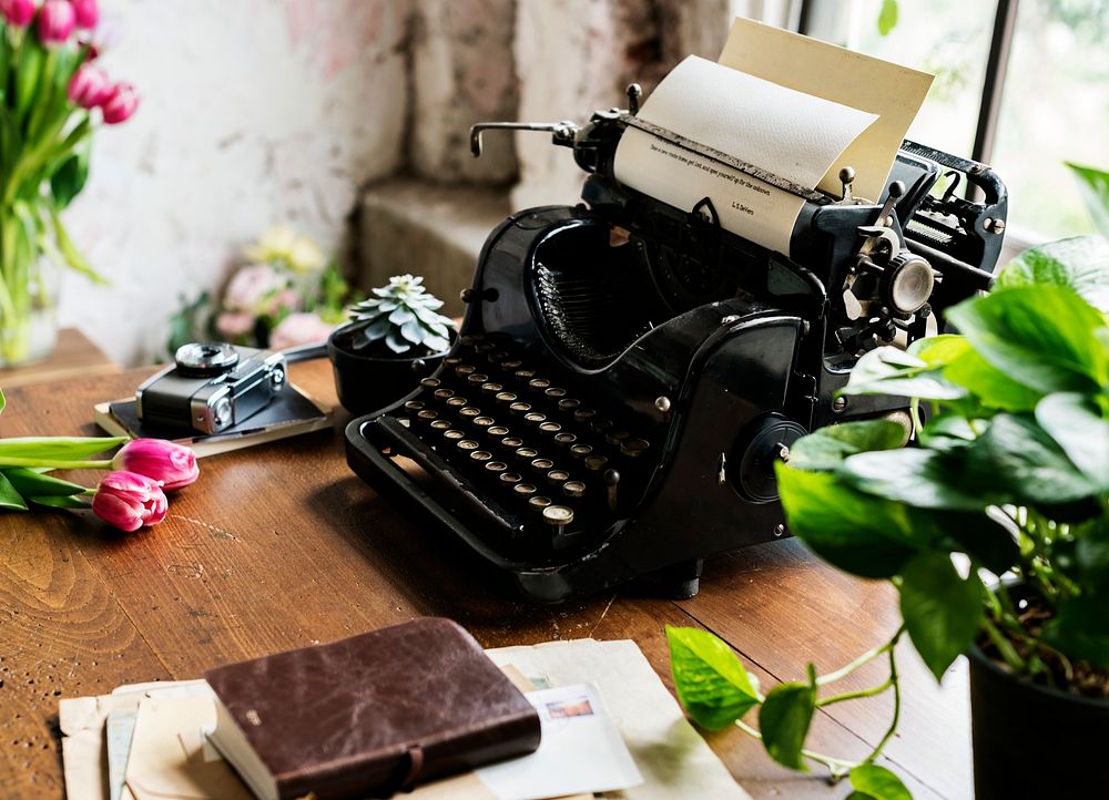 Vintage typewriter on a desk by a window