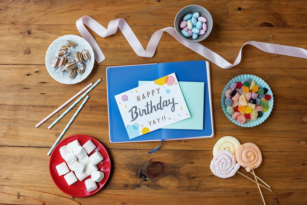 Birthday Wish Card on Wooden Table Background with Sweet Snacks