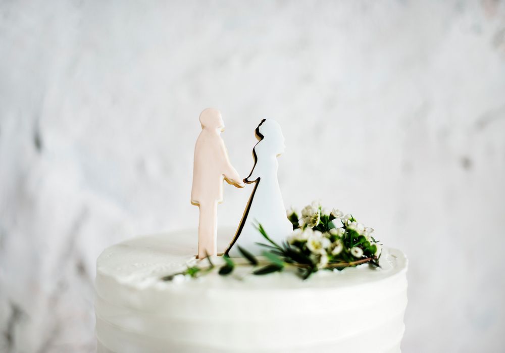 Closeup of groom and bride wedding cake topper