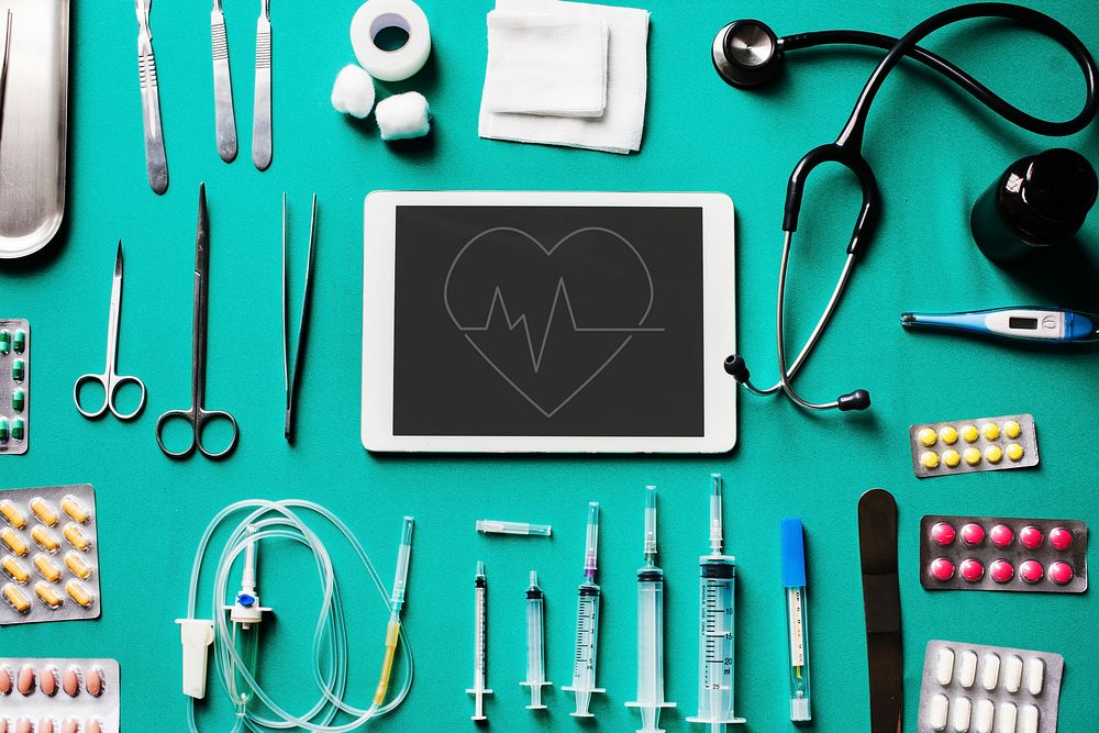 Digital tablet with medical tools on the table