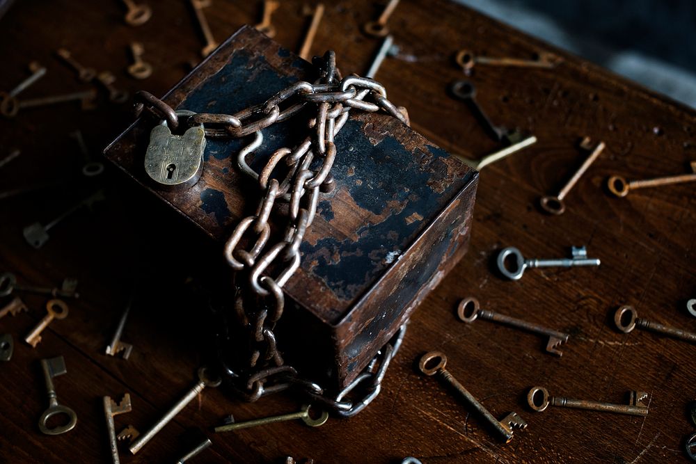 A chained rusty box surrounded by keys