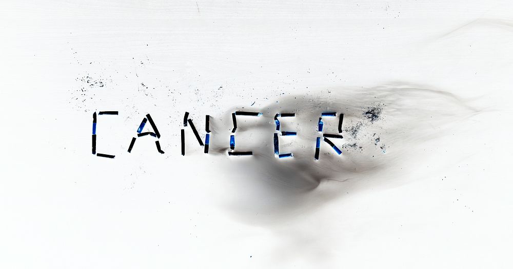 Negative image of cigarettes forming the word cancer