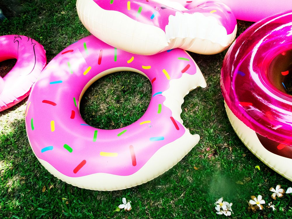 Closeup of inflatable tubes donut shape on green grass