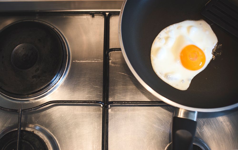 Closeup of fried egg in pan on stove