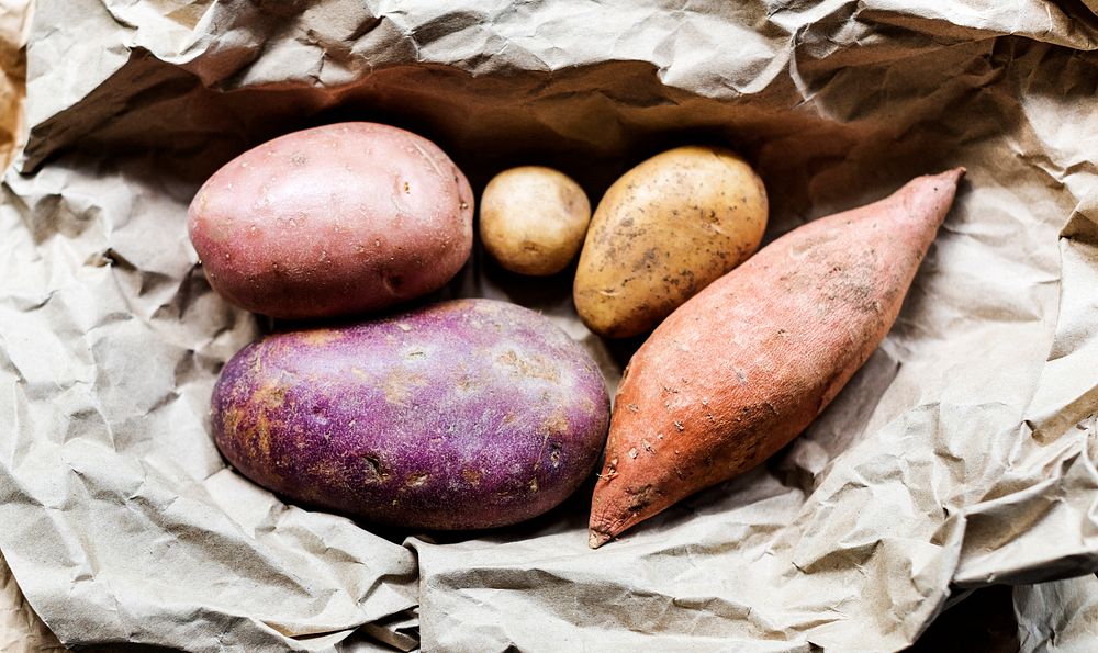 Different kinds of potato on a brown paper