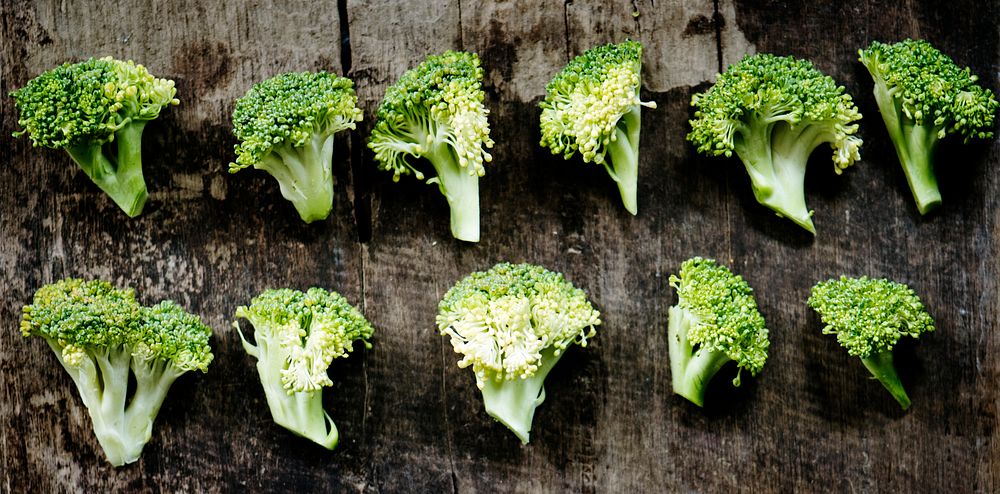 Aerial view of fresh cut broccoli on wooden background