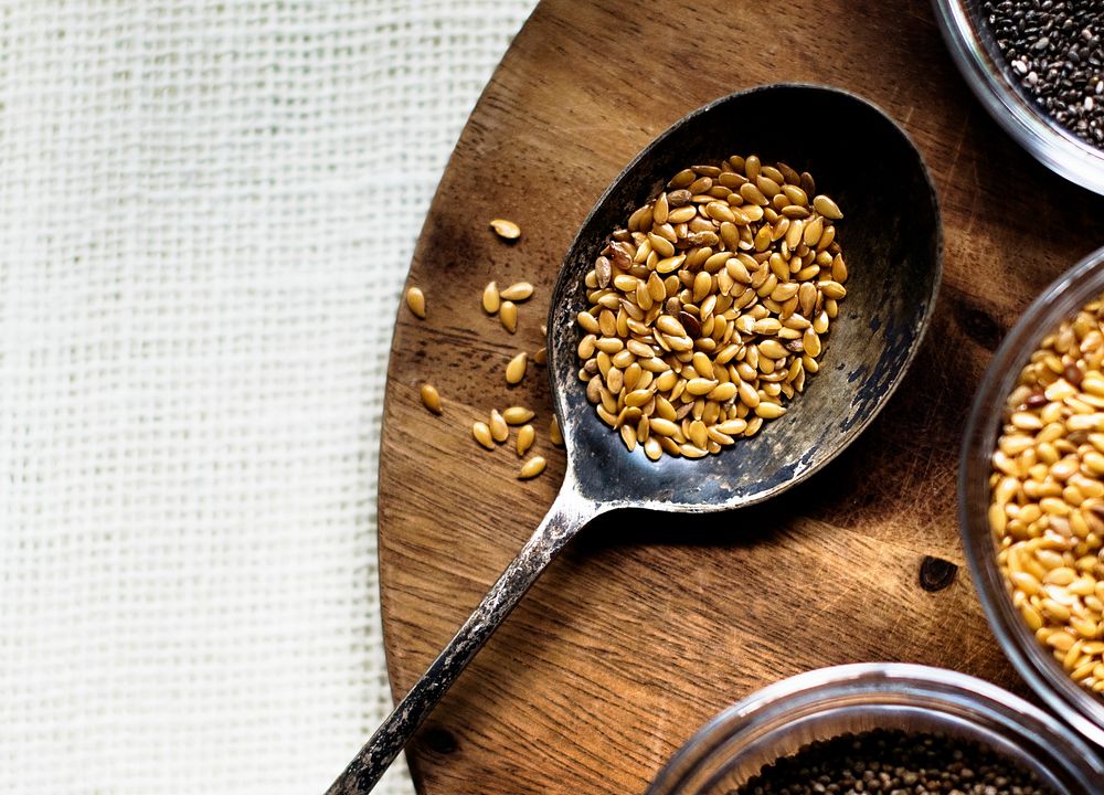 Aerial of seeds superfood on wooden board and spoon