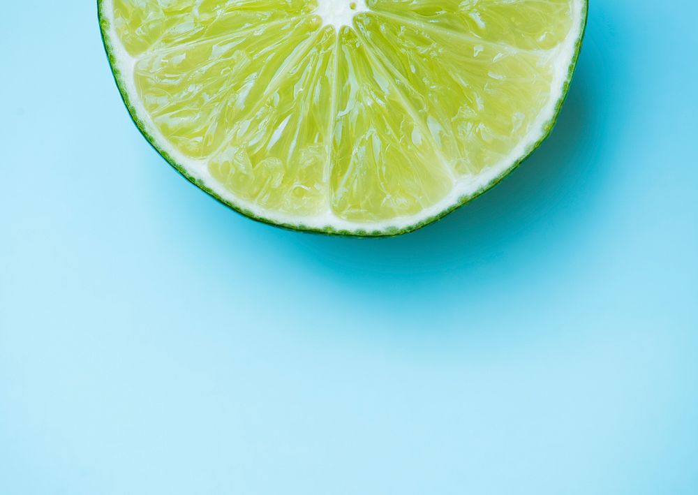 Slice lime on blue background