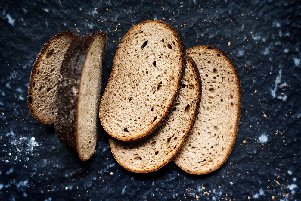 Slices of wheat loaf with black background