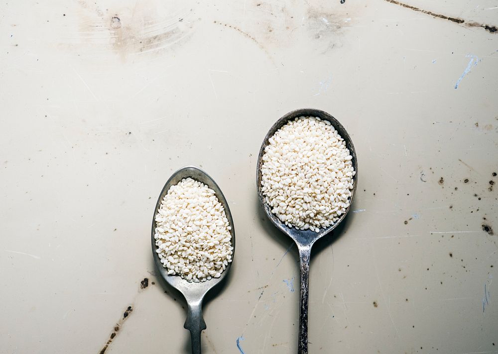 White sesame on spoon and white background