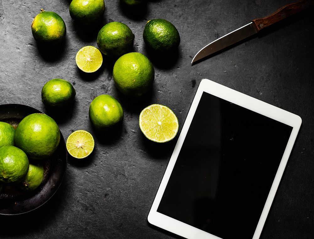 Closeup of fresh lime with digital tablet