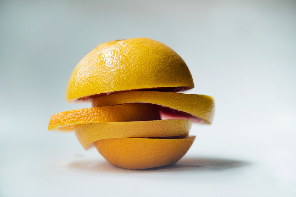 Closeup of oranges mixed with lemon pieces isolated on white